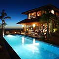 Nighttime view of villa from pool